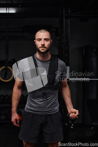 Image of A muscular man working arm exercises in a modern gym, showcasing his strength and dedication to fitness.