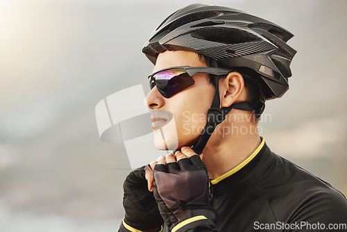 Image of Cycling, helmet and sunglasses with a sports man being safe while outdoor for a ride on a cloudy day. Safety, cycle and fitness with a male athlete outside to exercise or workout for cardio health