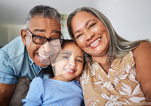 Image of Family, grandparents and child portrait in a house relaxing, bonding and having fun in retirement on a weekend. Smile, grandma and grandpa hugging and enjoy quality time with a happy girl in Bogota