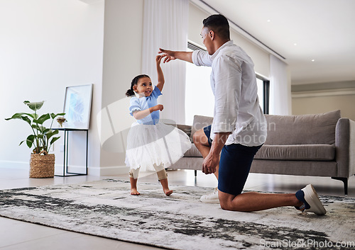 Image of Family, father and daughter dancing for fun, energy and love in the living room feeling happy holding hands to dance at home. Man or dad and girl child moving to favorite song on fathers day in house