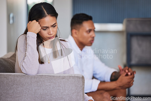 Image of Sad, woman and couple in unhappy marriage from argument, fight or disagreement on living room sofa at home. Upset female with married problems, trouble or issues with husband in divorce or breakup