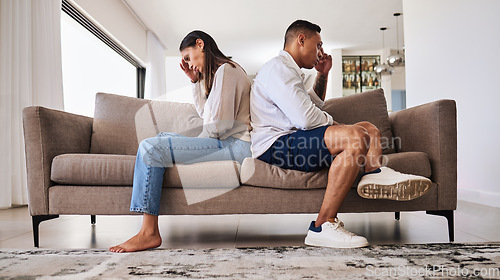 Image of Fight, frustrated and couple with a problem in their marriage on the living room sofa of their house. Sad, angry and depressed man and woman thinking of divorce, conflict and mistake on the couch