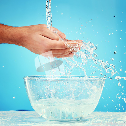 Image of Water bowl, health and hands splash liquid for hygiene, cleaning and wellness beauty routine with mockup. Water splash container, skincare and wet palm of self care man isolated on blue background