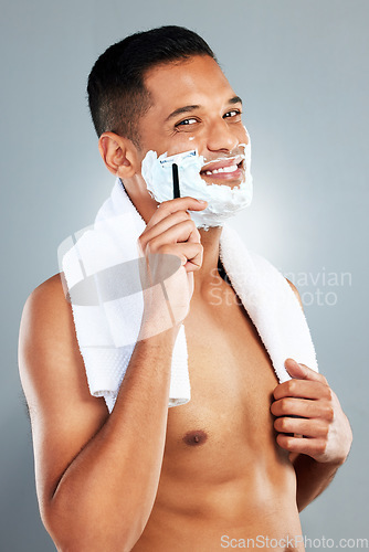 Image of Man shaving face, razor and shower for hair removal, aesthetic skincare and facial cleaning on grey studio background. Portrait happy naked guy, shave foam and body cream cosmetics for wellness