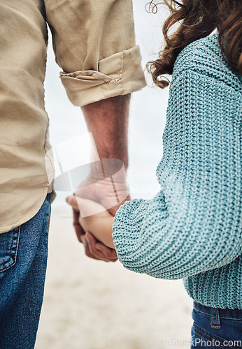 Image of Hands, family and children with a girl and grandfather holding hands while walking outside on the beach. Kids, love and trust with a senior man and granddaughter hand in hand on a walk outdoor