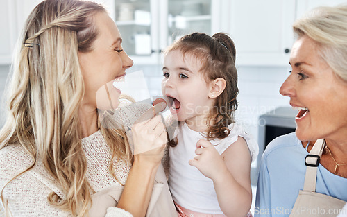 Image of Family, feeding and tomato with a girl and mother eating together in their home while grandmother comes to visit. Food, children and vegetables with a woman giving a daughter something healthy to eat