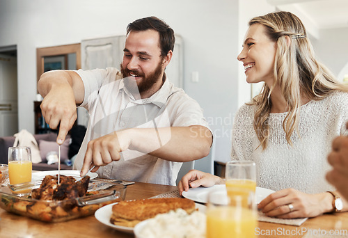 Image of Family, food and man cutting chicken at dinner party with woman smiling, eating and drinking together in dining room. Happy, care and celebrate, share time with couple and friends in home in Canada.