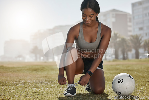 Image of Soccer, girl and black woman with shoes to start playing a football game for cardio exercise, workout and training. Sports, fitness and healthy athlete exercising ties boots on grass in Sao Paulo