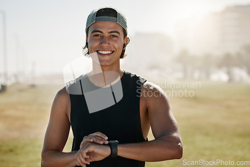 Image of Young, athlete and sports man happy outdoor in nature tracking fitness time watch after a run. Portrait of training, exercise and workout cardio of a person with health and happiness feeling strong