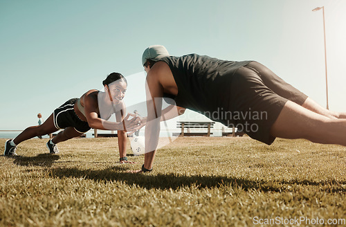 Image of Fitness, couple and support in plank and balance training during fitness, workout and exercise on a field. Sport, strong and fit athletes helping with motivation wellness challenge on grass field