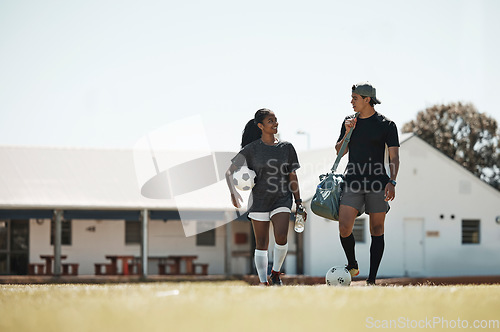 Image of Soccer, sport and couple training for fitness, outdoor cardio and game on a grass field together. Talking, happy and athlete man and woman with football for exercise, workout collaboration and sports