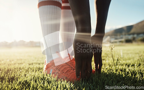 Image of Soccer player, stretching legs on grass and hands on shoes on pitch for sport fitness training start. Football, health and wellness workout for exercise warm up before Brazil summer game competition