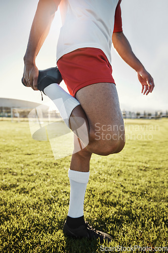 Image of Exercise, man and athlete doing stretching, prepare for training and practice for soccer game with workout in sportswear on field. Football, wellness and healthy male ready match, fitness and warm up