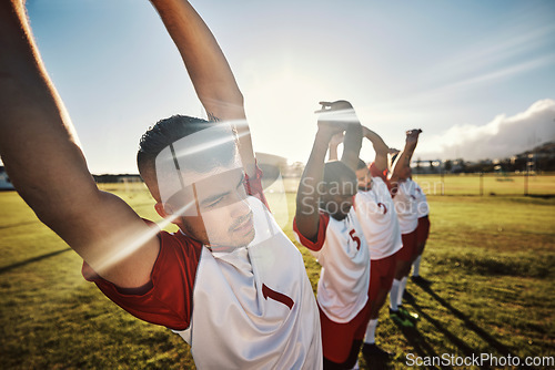 Image of Men football, team and stretching for fitness, wellness and health on a sports field in the morning. Diversity, exercise and soccer warm up start training healthy body for a game of sport outdoor