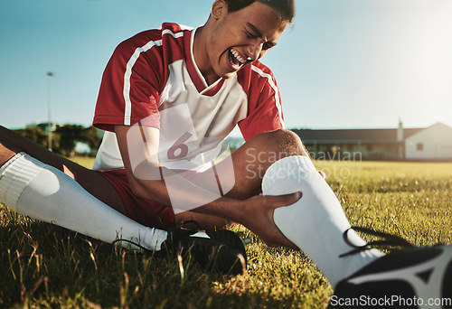 Image of Man, soccer and sport leg injury suffering in pain, agony and discomfort during training match or game on the field. Male football player screaming holding painful area in sports accident on grass