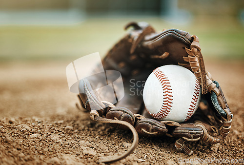 Image of Baseball, leather glove and ball on pitch sand after fitness, workout or training for match or competition. Zoom, texture and softball mitt on field for sports team, wellness exercise or stadium game