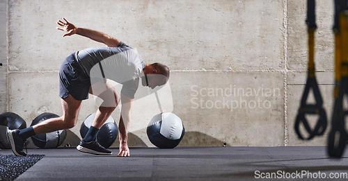 Image of A muscular man captured in air as he jumps in a modern gym, showcasing his athleticism, power, and determination through a highintensity fitness routine