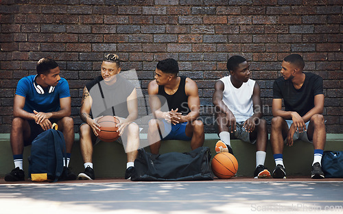 Image of Basketball, sport team and teamwork break speaking after exercise, workout and fitness. Black team training for sports collaboration and cardio rest together in a conversation about game strategy