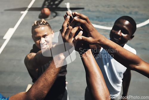 Image of High five, teamwork and basketball in closeup for support, motivation or match on basketball court. Basketball player, team and smile together for sport, game and success for team building in workout
