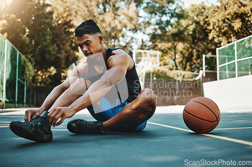 Image of Basketball court, man and shoes prepare for training at recreation and athlete facility. Sports, exercise and fitness male with lace tie getting ready for ball game workout and cardio.