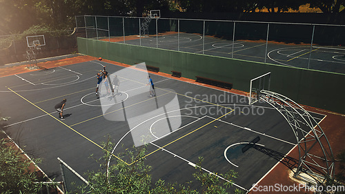 Image of Basketball, outdoor court and athlete men showing energy in ball sports competition or game for fitness and training. Above view, exercise and sport with community people playing streetball together