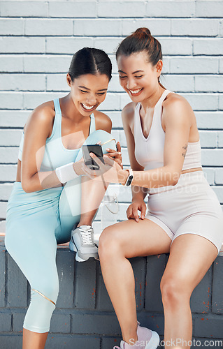 Image of Women, phone and laughing after city fitness, training and exercise for health, wellness or cardio health. Smile, happy or funny sports friends, people and runners with social media mobile technology