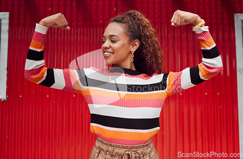 Image of Beauty, fashion and strong with a black woman flexing her muscle or bicep outdoor on a red background. Smile, proud and style with an attractive young female posing for strength or empowerment