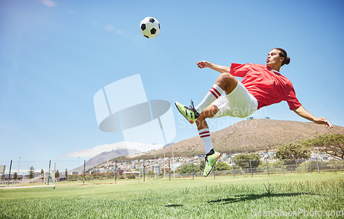 Image of Fitness, soccer and athlete scoring a goal at a game or sports training at an outdoor field. Skill, jump and man football player practicing a kick and score with ball exercise on pitch for motivation