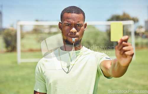 Image of Soccer, referee and yellow card with a black man booking a player on a grass pitch or field during a game. Fitness, football and discipline with a male ref giving a caution during a sports match