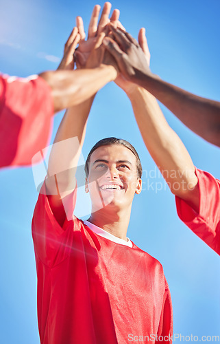 Image of High five, soccer and team in celebration of a goal and winning in a sports game or match outdoors in summer in Brazil. Success, fitness and happy friends or athletes reaching football score targets