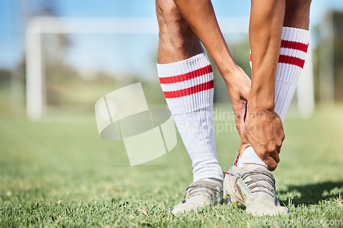 Image of Soccer, sports and ankle pain, injury or accident on a field during a game, exercise or training. Muscle sprain, broken joint or medical emergency of a man athlete at a football pitch during a match.