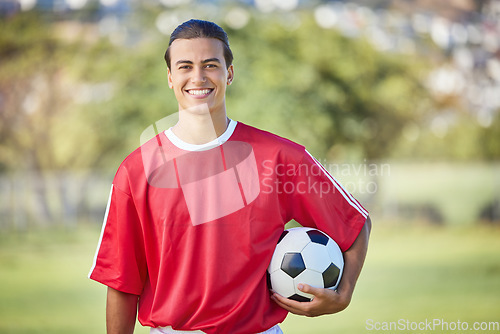 Image of Soccer, sports and fitness with a man athlete holding a ball on a field or grass pitch for training. Football, workout and exercise with a male player outdoor for health, wellness or practice