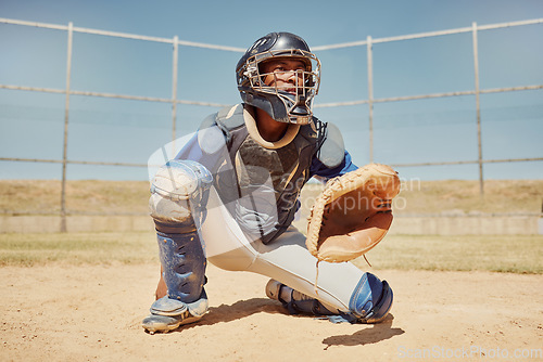 Image of Baseball, sports and man waiting on a field during a game, competition or training. Athlete catcher playing a sport with focus for exercise and fitness in nature or a park at an event in summer