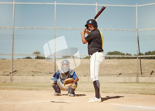 Image of Baseball, pitcher and man with a bat on pitch playing a match or sport training as a team. Fitness, sports and men athletes practicing pitching and batting before a softball game on an outdoor field.
