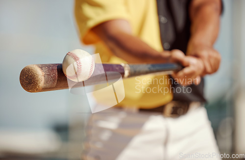 Image of Baseball, bat and ball being hit on a field at a sports training, practice or competition game. Softball, sport equipment and man athlete practicing to swing a wood baton on outdoor pitch or stadium.