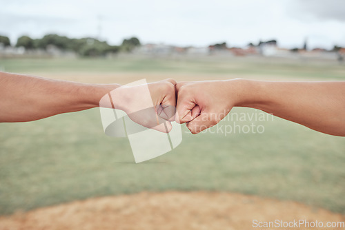 Image of Hands, fist bump and friends outdoor in nature for partnership, friendship and support on a field. Baseball or softball pitch, team building and men athletes doing a solidarity gesture together.