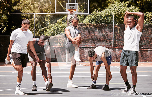 Image of Fitness, exercise and basketball men stretching or workout their body on a sport court. Training male athletes prepare muscle warm up before practice or game at a sports venue or club for health