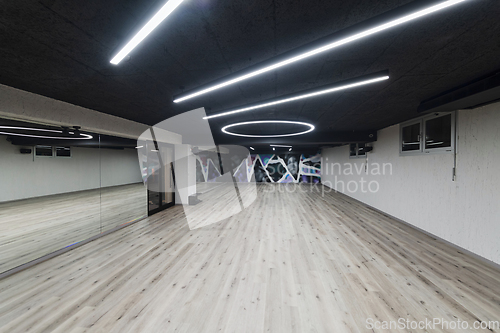 Image of An empty dance hall with a glass wall adorned with decorative graffiti, offering a fusion of contemporary, urban artistic ambiance and impressive aesthetics.