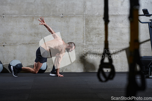 Image of A muscular man standing in the starting position for running, exuding determination and readiness for an intense fitness workout or athletic competition.