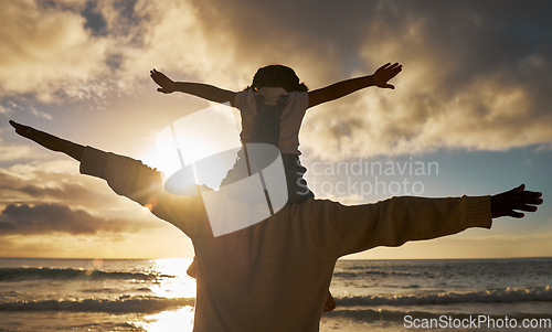 Image of Father, child and shoulders flying on the beach enjoying the sunset together for family bonding in the outdoors. Dad with kid pretend to fly on piggyback fun in nature for relationship, love and care