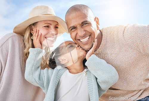 Image of Happy family, mother and father with a kiss from a child on the face in summer outdoors on a weekend. Interracial, mama and girl loves kissing dad with a big smile on cheek on sunny holiday vacation
