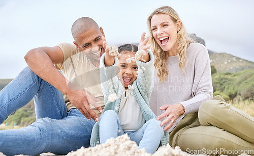 Image of Children, family and beach with girl, mother and father playing in the sand while bonding on holiday or vacation. Travel, kids and summer with a woman, man and daughter bonding together at the coast