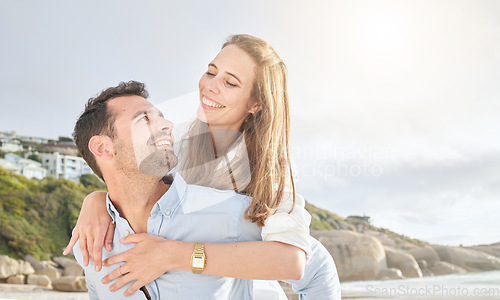 Image of Love, beach and couple piggy back for tender moment of romance and happiness in Los Angeles. Romantic relationship with happy people dating and bonding while playing at ocean getaway in the USA.