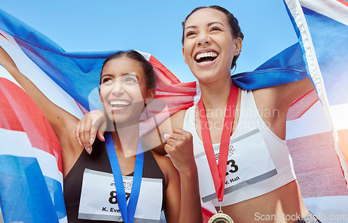 Image of Success, women and running team with a flag in celebration of winners medals achievement at a sports event. Fitness, British and happy athlete runners excited to celebrate winning gold with pride