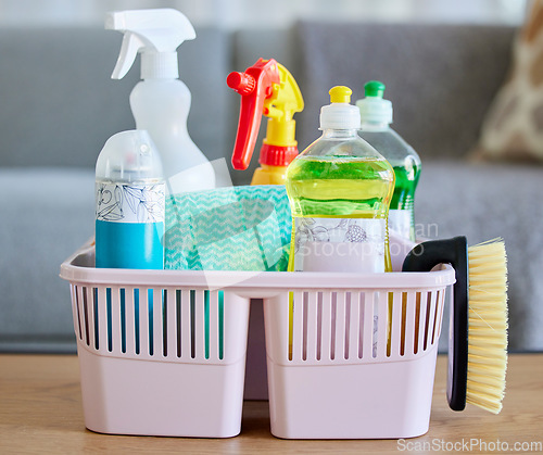 Image of Cleaning supplies, brush and basket tools on table in home living room for hygiene. Cleaning products, spring cleaning and equipment for creating germ free living space, sanitizing or washing.