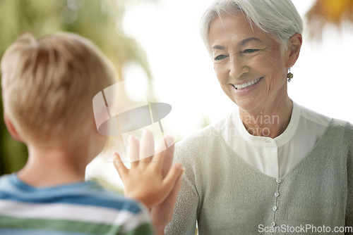 Image of Covid, grandmother and child touching window for safety, social distancing and risk in covid 19 pandemic. Family, love and boy connect hand with grandma on glass in isolation, quarantine and lockdown