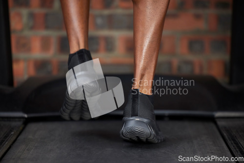 Image of Runner, feet and shoes on treadmill in gym workout, training and workout for heart cardio health, wellness and energy. Zoom, black man and sports marathon athlete running in fitness practice for race