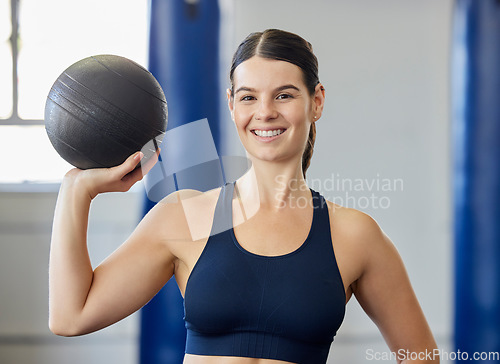 Image of Sports, training and woman with a medicine ball for exercise, fitness and body goal at gym. Portrait of happy, healthy and athlete with a smile for workout for wellness at club for health and cardio
