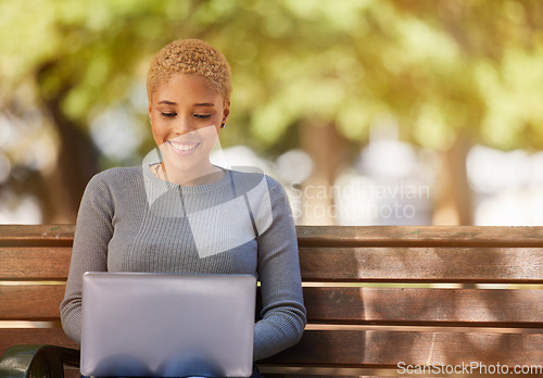 Image of Woman, laptop and smile in park while on social media, reading or writing on web. Black woman, writer and happy with computer in sunshine to relax outdoor by trees for study, poetry and technology