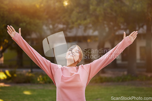Image of Freedom, nature and happy woman in park to relax and have fun outdoor in nature for peace, quiet and freedom mindset. Happiness, fitness and spiritual zen girl with arms outstretched being mindful